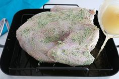 a large piece of meat is being poured into a pan with butter and seasoning