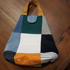 a multicolored bag sitting on top of a wooden floor