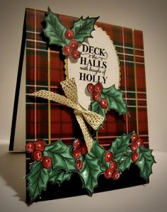 a christmas card with holly and red berries on it, featuring the words deck the hall