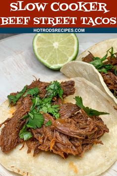 slow cooker beef street tacos with cilantro and lime on the side