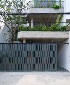 an entrance to a building with plants growing on the balconies