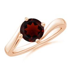 a gold ring with a red stone in the center