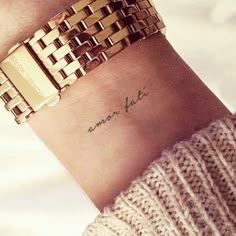 a woman's wrist with an arm tattoo that reads, amon la vie