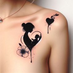 a woman's shoulder with tattoos on it and a flower in the shape of a heart