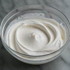 a bowl filled with whipped cream on top of a table