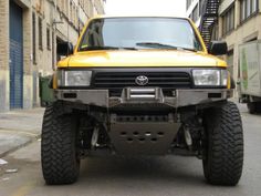 a yellow truck parked on the side of a street