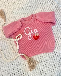 Looking for a unique and thoughtful gift for a new baby? A unique hand embroidered sweater for a special birthday kid?  This handmade sweater with embroidered strawberry design is a charming and one-of-a-kind item or gift that will be cherished for years to come. This oversized sweater is for babies, toddlers and children. You can add your name personalization in the box at check out.  This listing is for a baby name sweater with embroidered RED STRAWBERRY. Please see our other baby name sweater Personalized Pink Sweater For Winter, Personalized Pink Crew Neck Sweater, Cute Pink Sweater With Custom Embroidery, Handmade Sweater, Red Strawberry, Embroidered Sweater, Special Birthday, Custom Embroidery, Baby Announcement