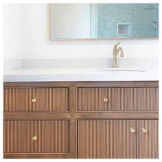 Cabinet doors make a huge difference in the overall look of a bathroom, so consider embellished styles like reeded doors to add a contemporary style. While the cabinet doors are the main embellishment in this bathroom, the metallic hardware and faucet infuse a look of luxury. The simple white walls and countertop allow the other features to stand out...   Image: the.design.nook