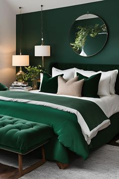 a bed with green sheets and pillows in a bedroom next to a mirror on the wall