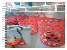 red baskets are hanging on the shelves in a store, and one is holding an umbrella