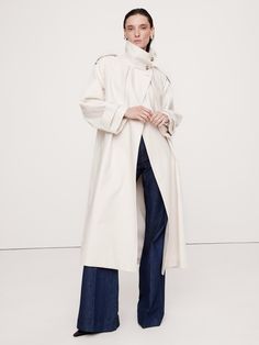 An ode to the best utility styles in our archives, this trench coat is cut from a cotton twill we sourced from Italy, one we love for its dressed-up appearance.  Here, we cut it in an oversized fit with classic trench coat details like a shoulder epaulets and storm flaps.  Warm: Lightly lined through the body for easy layering through the seasons.  Oversized fit with dropped shoulder and wide sleeves.  Fabric from Italy's Olimpias mill.  Stand collar with button front and belted closure.  Interi Coat Details, Outerwear Trends, Coat Trends, Classic Trench Coat, Suede Coat, Shearling Coat, Wide Sleeves, Cream White, Stand Collar