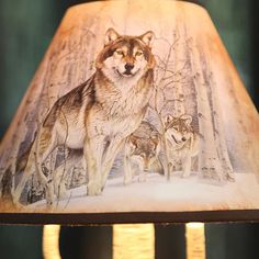 a lamp shade with a wolf painting on it