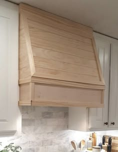 a stove top oven sitting inside of a kitchen next to white cabinets and counter tops