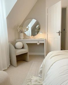 a bedroom with a bed, mirror and dressing table in it's corner area