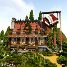 an image of a large house in the middle of some trees and bushes with a giant object hanging from it's roof