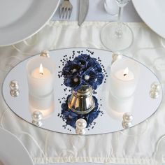 candles and flowers on a glass plate with pearls