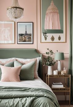 a bedroom with pink walls and green bedding, chandelier and pictures on the wall