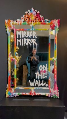 a man taking a selfie in front of a mirror with the words mirror mirror on it