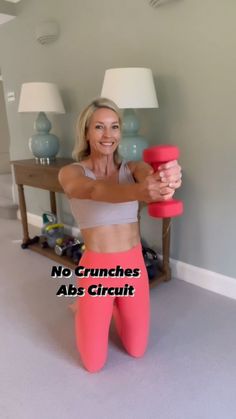 a woman in pink leggings holding a red object with the words no crunches abs circuit