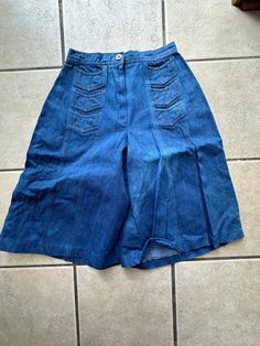 This pair of vintage 70's denim gaucho pants are very wide leg.  They have six front v shaped small front pockets with a zipper and butting front closure.  There is some fading as shown in pictures, but other than that they are in good condition. Waist-26 inches Hips -40 inches Rise-12 inches Inseam-14 inches Waistband width- 1.25 inches Bell bottom circumference-34 inches  To see more of our authentic 1970's vintage clothing please visit our store at ChoiceRecycling.  We add new items every week. Thank you, Karmyn 70s Denim, Gaucho Pants, Womens Trousers, Knee Length Shorts, Bell Bottom, V Shape, Bell Bottoms, Vintage 70s, Trousers Women