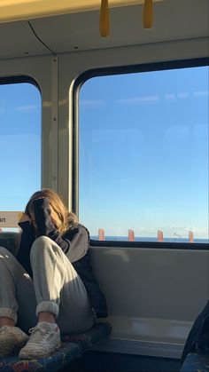 a person sitting on a bus looking out the window