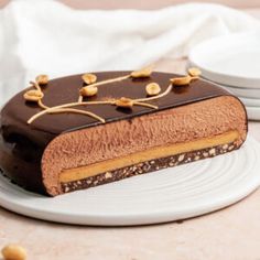 a piece of cake sitting on top of a white plate next to two plates with nuts