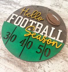 a wooden sign that says hello football season 30 - 50 % off on the side