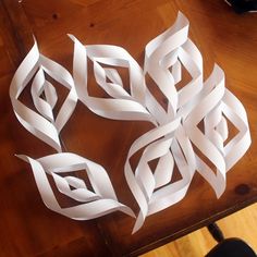 some white origami pieces on a wooden table