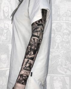 a man's arm covered in black and white tattoos, with pictures on it