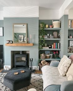 a living room filled with furniture and a fire place next to a book shelf full of books