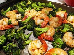 shrimp and broccoli are being cooked in a pan with an apple beside it