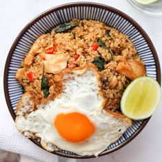 a bowl filled with rice and fried eggs