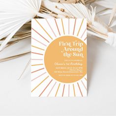 the first trip around the sun birthday party card is on top of some palm leaves