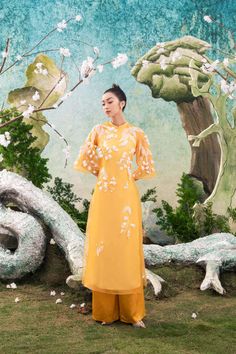 The image of delicate and meticulous embroidered white flowers on a yellow background makes others feel the beauty of nature easily attracts people at first sight. The Ao Dai is very suitable to wear on holidays and important events. Note:*Processing time takes 12-15 working days (including 11-13 working days for manufacturing and NOT including shipping time)**Made To Order Definition:- The product is currently unavailable and not in mass production.- The product will be manufactured immediately Organza Mini Dress, Mean Blvd, Vietnamese Dress, Yellow Background, Red Valentino, Ao Dai, Fancy Dresses, Flared Sleeves, S Models