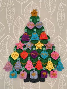 a crocheted christmas tree with bells on it