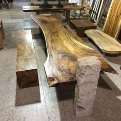 several wooden benches sitting on top of a floor next to each other in a room