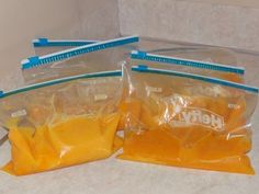 three bags of cheese sitting on top of a counter