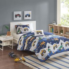 a child's bedroom with blue walls and white bedding, toy cars on the floor