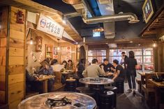 a group of people sitting at tables in a restaurant