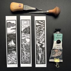 three bookmarks with scissors and some other items on a black table next to them