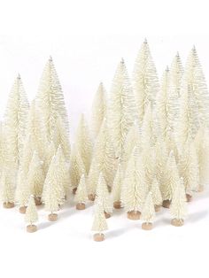 small white christmas trees lined up against a white background