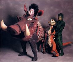 three people in costume standing next to an animal