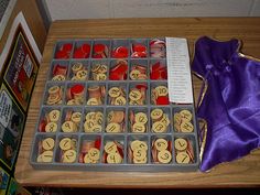 an assortment of cookies and candy in trays on a table with purple satin bow