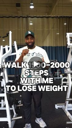 a man standing in front of a weight machine