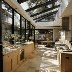 an open kitchen and dining area with skylights