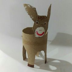 a donkey made out of toilet paper with a red nose and mouth on it's head