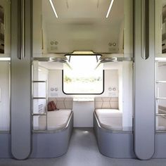 the inside of a bus with bunk beds