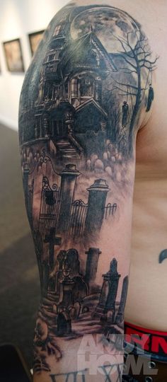 a man with a tattoo on his arm has a house and graveyard scene in the background