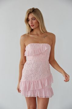 Make an entrance in the Cece Strapless Lace Ruffle Tie Back Mini Dress! This gorgeous dress features a strapless neckline, lace up back, and a floral lace overlay with polkadot ruffle details. Available in dusty pink and white! Pair with a simple heel to complete the look! Details 100% Polyester Ruffle hem Boning for structure Silicon grip Hidden back zipper with clasp Hand wash cold / Line dry Spring Fling Dress, Cute Formal Dresses, Cute Homecoming Dresses, Rush Dresses, Rosie Huntington, Prom Dress Inspiration, Lace Strapless, Huntington Whiteley, Ruffle Mini Dress