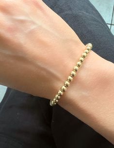 This Italian 14K Yellow Gold Ball Chain Bracelet is ideal for everyday wear. Measuring 7" in length, it features 3mm and 4mm links secured with a lobster clasp. Thank you for visiting our shop!Visit our website DmKJewelry.comAlso Follow us on Instagram https://www.instagram.com/dmkjewelryny/ Everyday Flexible Round Gold Bracelet, Classic Everyday Round Beaded Bracelets, Classic Single Strand 14k Gold Bracelet, Classic 14k Gold Single Strand Bracelet, Classic 14k Gold Beaded Bracelets For Everyday, Classic Everyday 14k Gold Beaded Bracelets, Everyday Classic 14k Gold Beaded Bracelets, Classic Hand-strung Gold Bracelet, Classic Single Strand Beaded Bracelets For Everyday